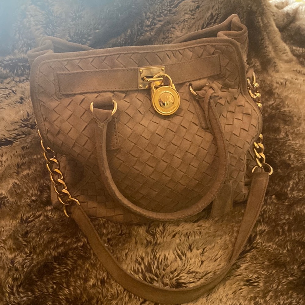 Michael Kors suede handbag with gold-toned lock and strap.